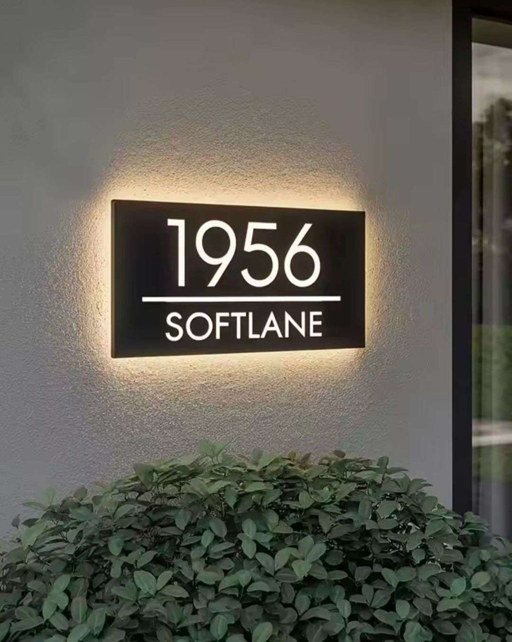 Custom rectangular LED light-up house address sign displaying 1956 Softlane on exterior wall at night