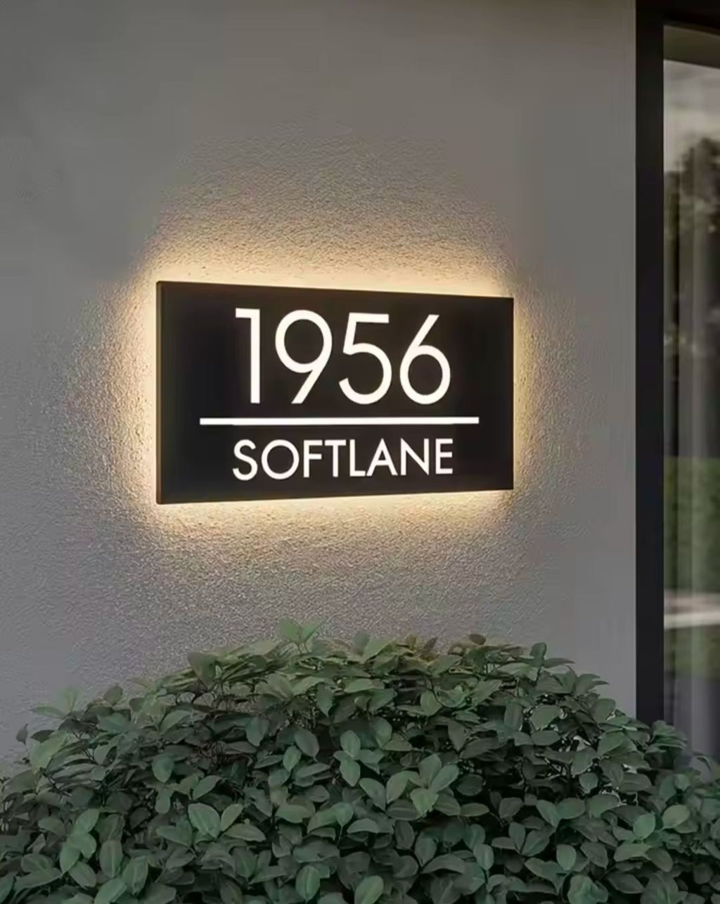 Custom rectangular LED light-up house address sign displaying 1956 Softlane on exterior wall at night