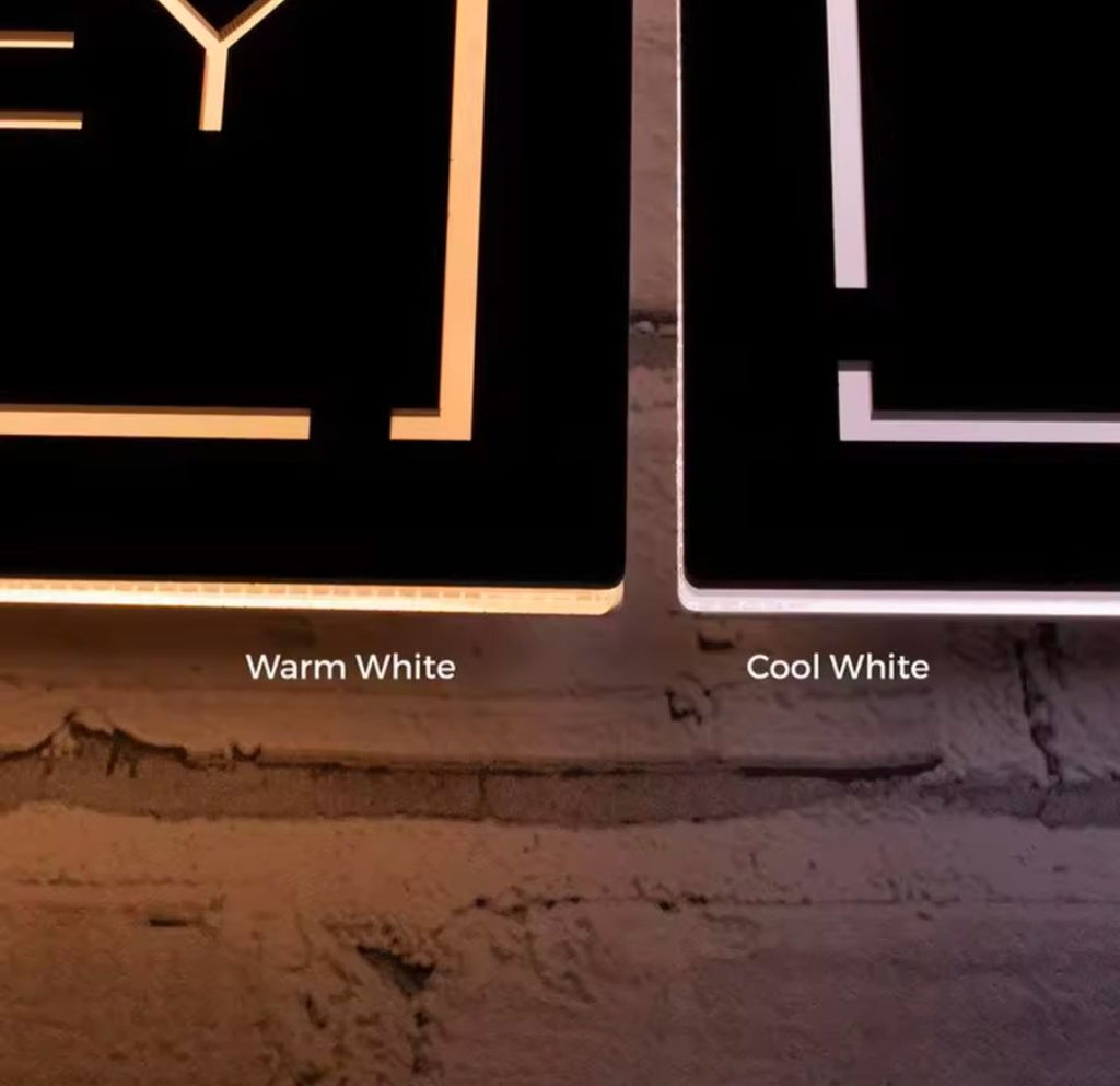 Comparison of warm white and cool white LED light options on rectangular custom house address signs mounted on a brick wall