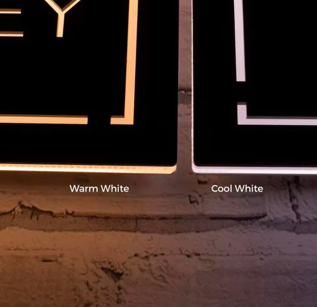 Comparison of warm white and cool white LED light options on rectangular custom house address signs mounted on a brick wall