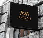 Rectangular black acrylic LED lightbox sign with gold Avalon Fashion Industry logo mounted on stone exterior wall