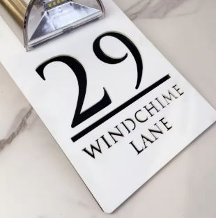 Rectangular solar-powered custom acrylic house sign with address number 29 and Windchime Lane text