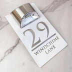 White rectangular custom acrylic house sign with silver laser-etched address and solar LED light on top