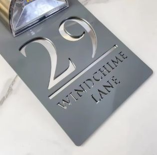Custom rectangular solar acrylic house address sign with laser-cut number 29 and Windchime Lane text