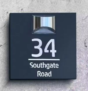 Square custom acrylic house sign with laser-etched address number 34 Southgate Road and solar light above