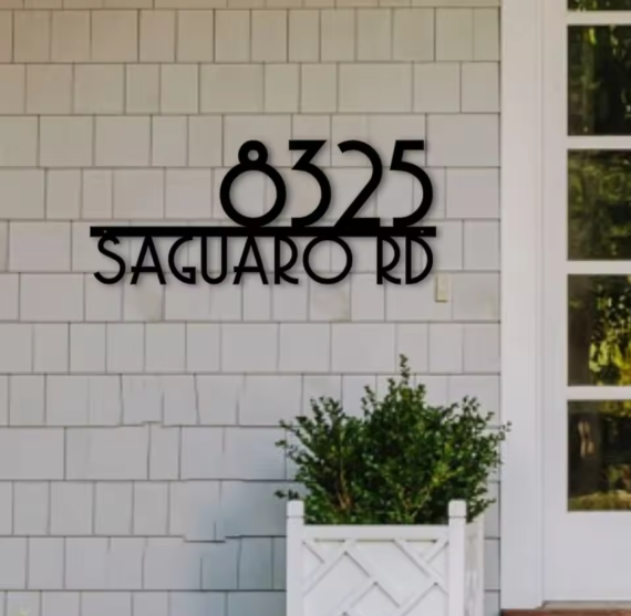 House number sign '8325 Saguaro Rd' on a tiled wall.