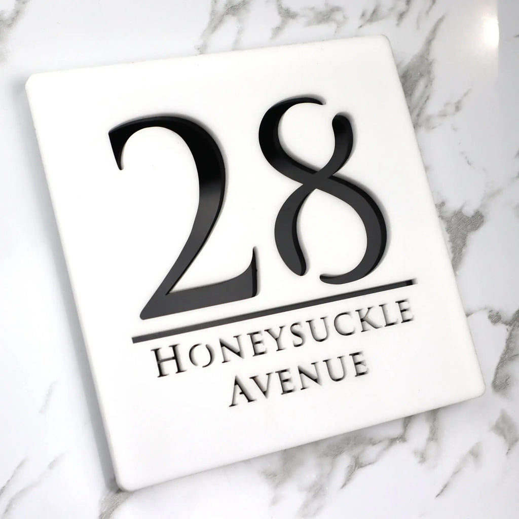 Square custom acrylic house sign displaying number 28 and Honeysuckle Avenue in black text on white background