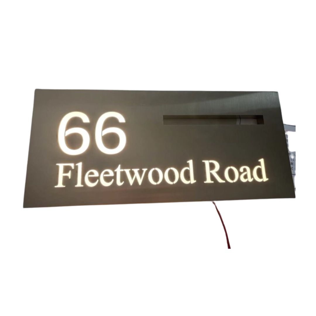 Illuminated stainless steel LED mailbox slot with custom house number and Fleetwood Road address sign.