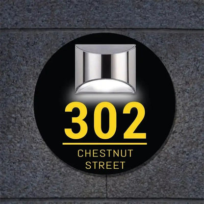 Circular black acrylic house sign with silver light, yellow address number 302, and Chestnut Street text